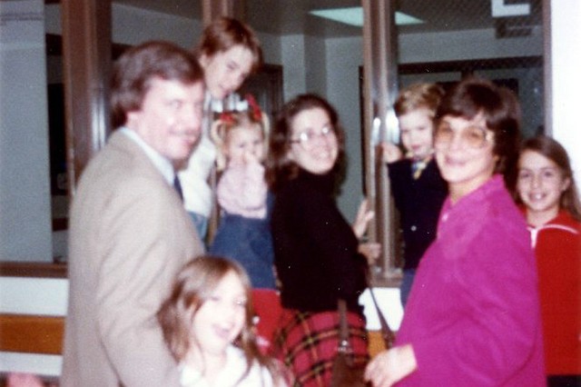 Julie_076.jpg - The neighborhood welcoming committee.  You became a member of each of the Angus Trail circle families from the very beginning.  Here Dad, Margo, John, Leighanne, Anita, James, Mom, and Karen gather to celebrate your arrival.  The picture is not great, but we could not leave out the tribute to the families who were a big part of your early life.